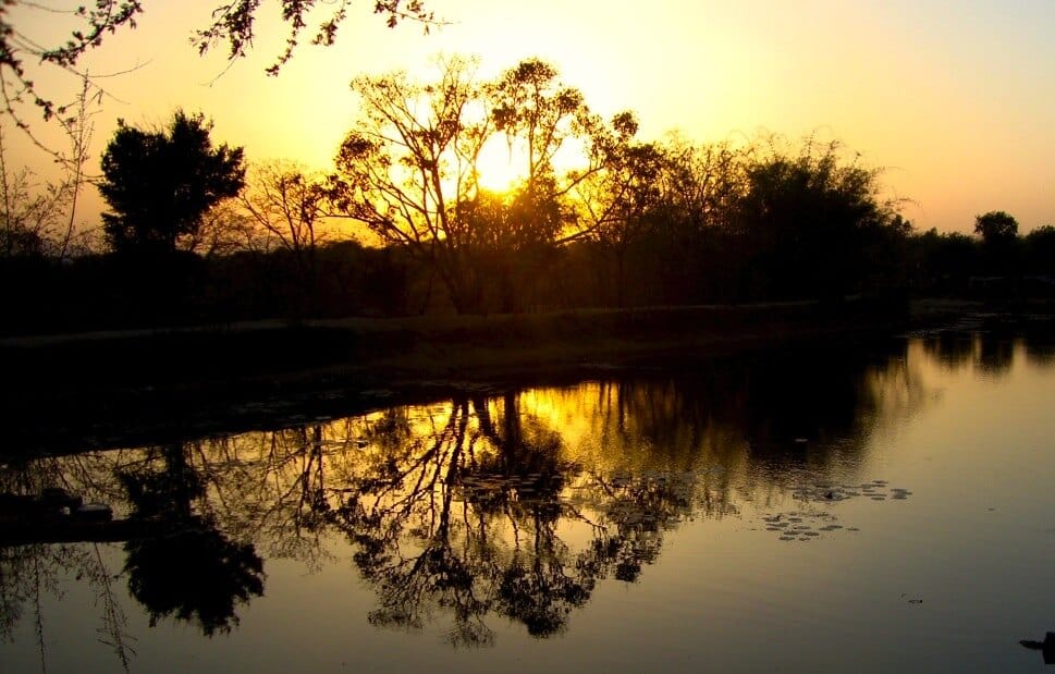 Evening light over the water Warm evening light reflected across water at Ánanda Nagar