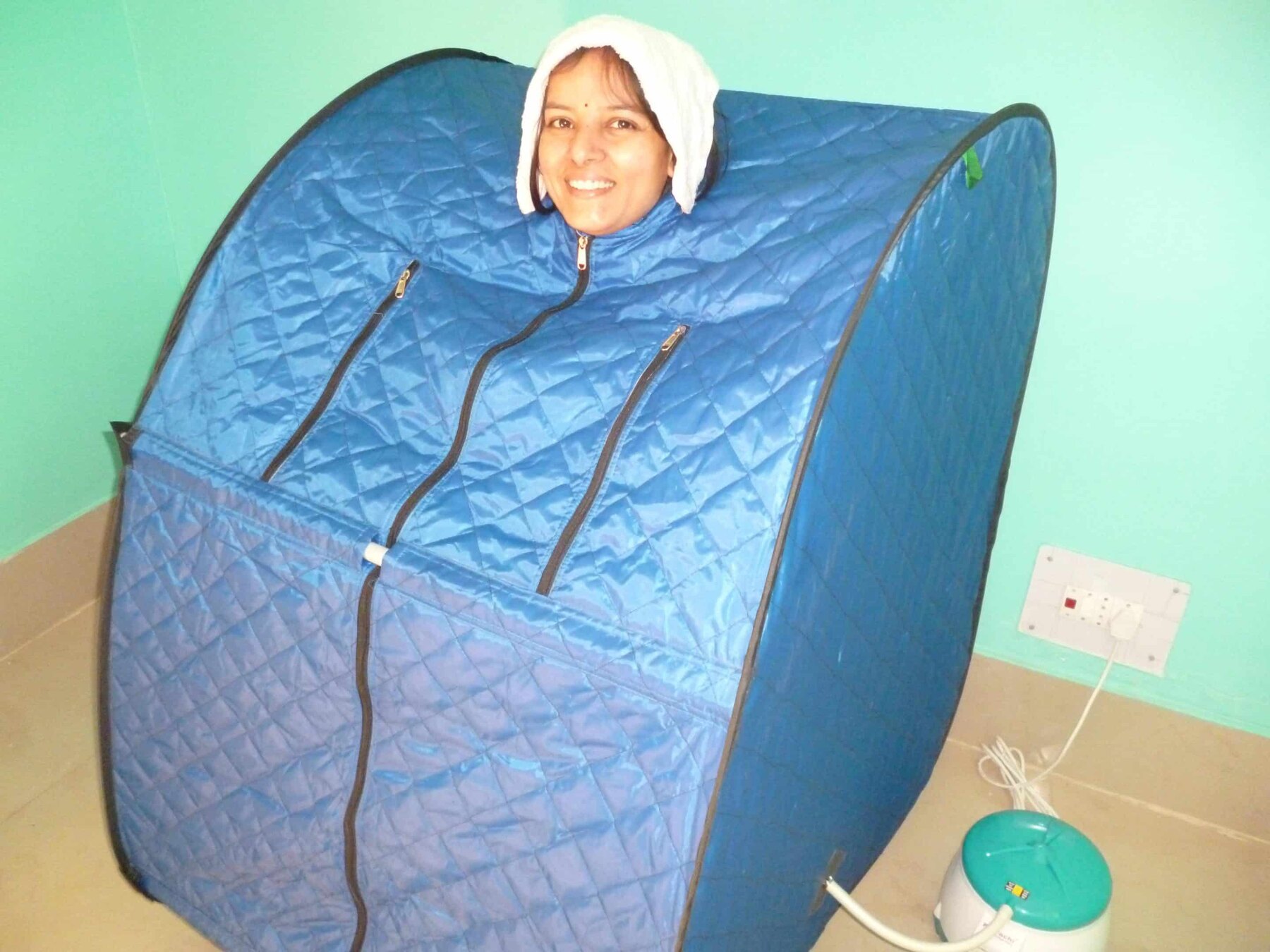 A guest receiving a supervised steam-bath treatment at the centre